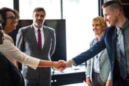 woman shaking hands, women in senior positions featured