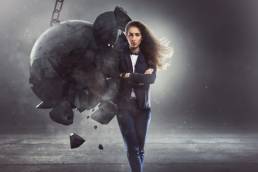 resilient business woman, woman being hit by wrecking bacll