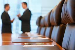 CEOs talking in a boardroom