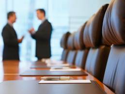 CEOs talking in a boardroom