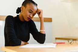 Sad woman at desk, Blue Monday