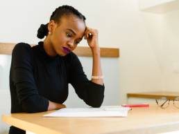 Sad woman at desk, Blue Monday