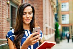 Woman looking at phone, job seeking Glassdoor
