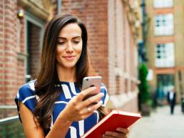 Woman looking at phone, job seeking Glassdoor