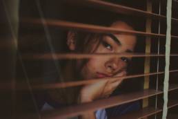 sad woman looking out of her window, Blue Monday