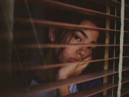 sad woman looking out of her window, Blue Monday