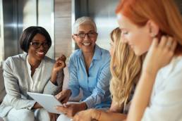 Happy business woman working together online on a tablet, menopause