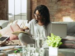 diverse woman working from home on sofa