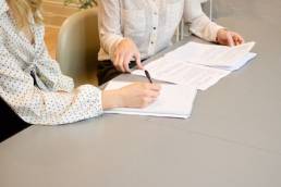 two female recruiters discuss applicants CV