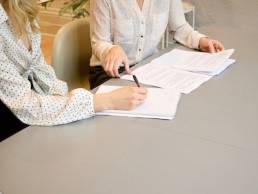 two female recruiters discuss applicants CV