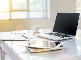 The tipical office desktop with pc, pens, notebook, laptop