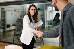 Openly greeting a job recruiter with a firm handshake, recruitment industry, new role