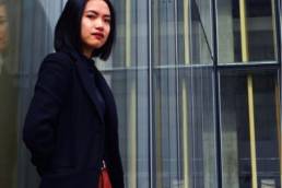 asian woman standing outside her work, returning to work 1