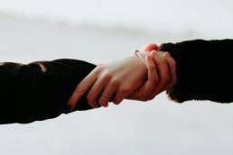 man and woman holding hands, mental health, wellbeing, mindfulness