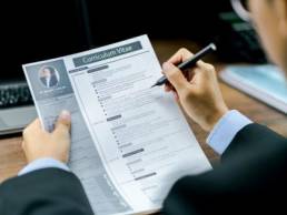 man looking at a CV, curriculum vitae, resume