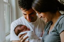 new parents looking at baby, paternity leave, maternity leave, mum, dad