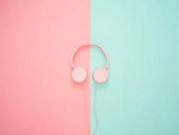 pink headphones on background, wearing headphones at work