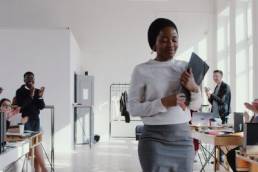 shy, introverted woman being clapped in the office