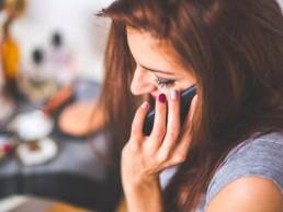woman talking on the phone while working from home