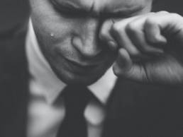 man wiping away tear, grief, bereavement