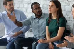 Angry diverse multiethnic applicants argue with confident female before recruitment talk, mad multiracial male candidates discriminate woman intern before interview, gender discrimination concept