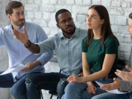 Angry diverse multiethnic applicants argue with confident female before recruitment talk, mad multiracial male candidates discriminate woman intern before interview, gender discrimination concept