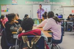man giving a talk for children in classroom, school, Future First