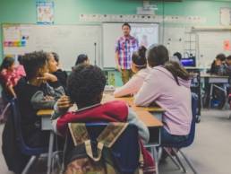 man giving a talk for children in classroom, school, Future First