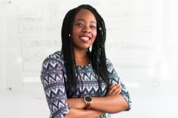 smiling black business woman with her arms crossed, Louise Findlay-Wilson