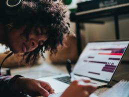 woman wearing headphones and studying