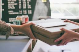 woman buying pizza from a local business, shop local, Erica Wolfe Murray