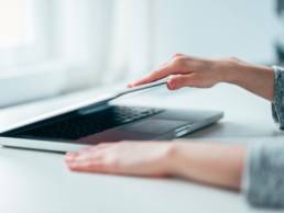 Close-up image of female hands open or close laptop on white table, work-life balance, working from home