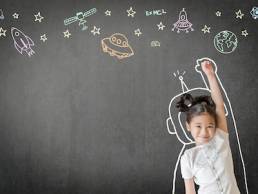 Kid's learning inspiration world in science education with girl child's imagination doodle on teacher's school chalkboard for back to school month and international or universal children's day concep