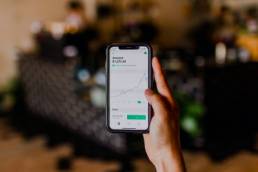 Person holding black iPhone, stock market, investors