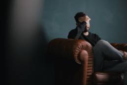 man holding his head in his hands, sad, divorce