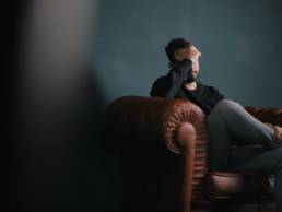 man holding his head in his hands, sad, divorce