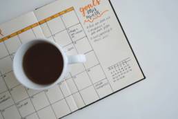 goals, planner with a cup of coffee