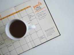 goals, planner with a cup of coffee