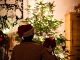 parent and child looking at Christmas tree, work-life balance, festive season