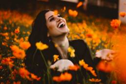 woman smiling in a field of flowers, growth, grow