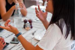 woman talking animatedly about herself, woman with friends in a cafe, soft skills
