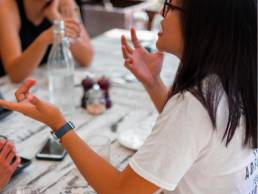 woman talking animatedly about herself, woman with friends in a cafe, soft skills