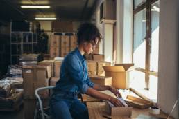 Ecommerce, Female business owner working, packing the order for shipping to customer