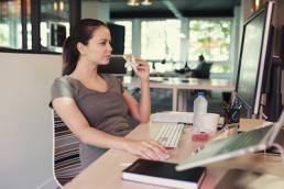 Casual Creative Freelancer Woman Eating A Sandwich In Front Of A Computer, working lunch