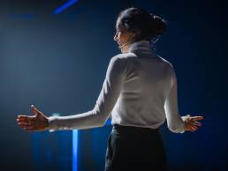 Female Motivational Speaker on Stage, Talking about Happiness, Diversity, Success, Leadership, STEM and How to Be Productive. Woman Presenter Leads Tech Business Conference.