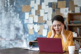 Troubled young asian woman. Remote work.