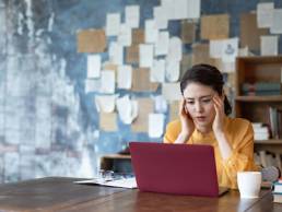 Troubled young asian woman. Remote work.