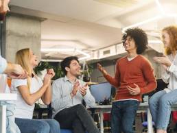 Creative team enjoying communication in modern office, discussing ideas for startup, empty space, International Youth Day