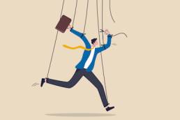 Freedom for work and decision making, authority to work independently, stop micromanagement, or people manipulation concept, businessman marionette, puppeteer use scissors to cut controlled strings.