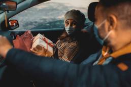 Family shopping Christmas gifts during COVID-19 pandemic. They wears a protective mask to protect from coronavirus, COVID-19, omicron